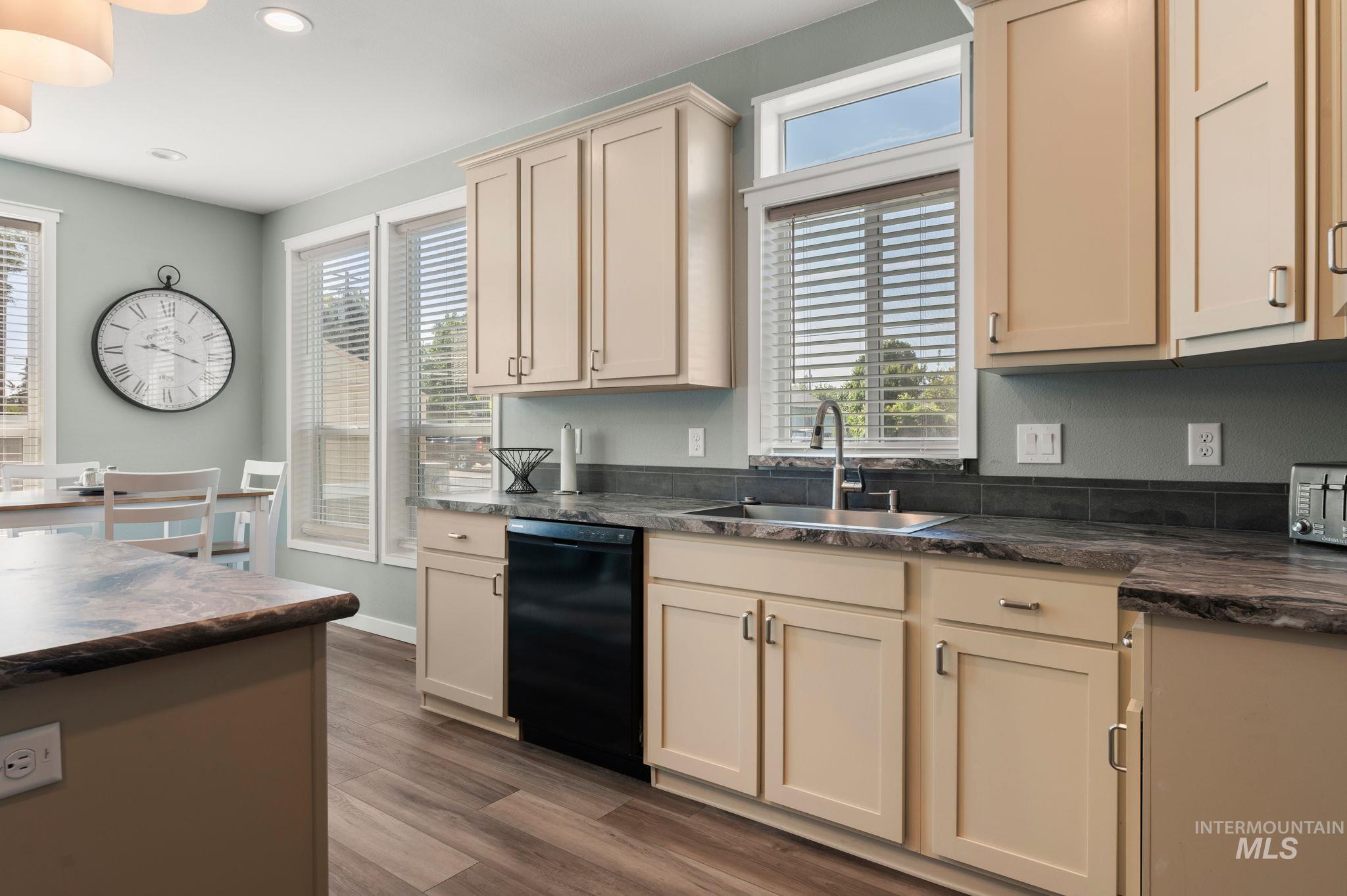 837 Burrell Avenue Lewiston, ID 83501 - Photo 23 of 32 Kitchen with dark countertops, black dishwasher, healthy amount of natural light, wood finished floors, and recessed lighting