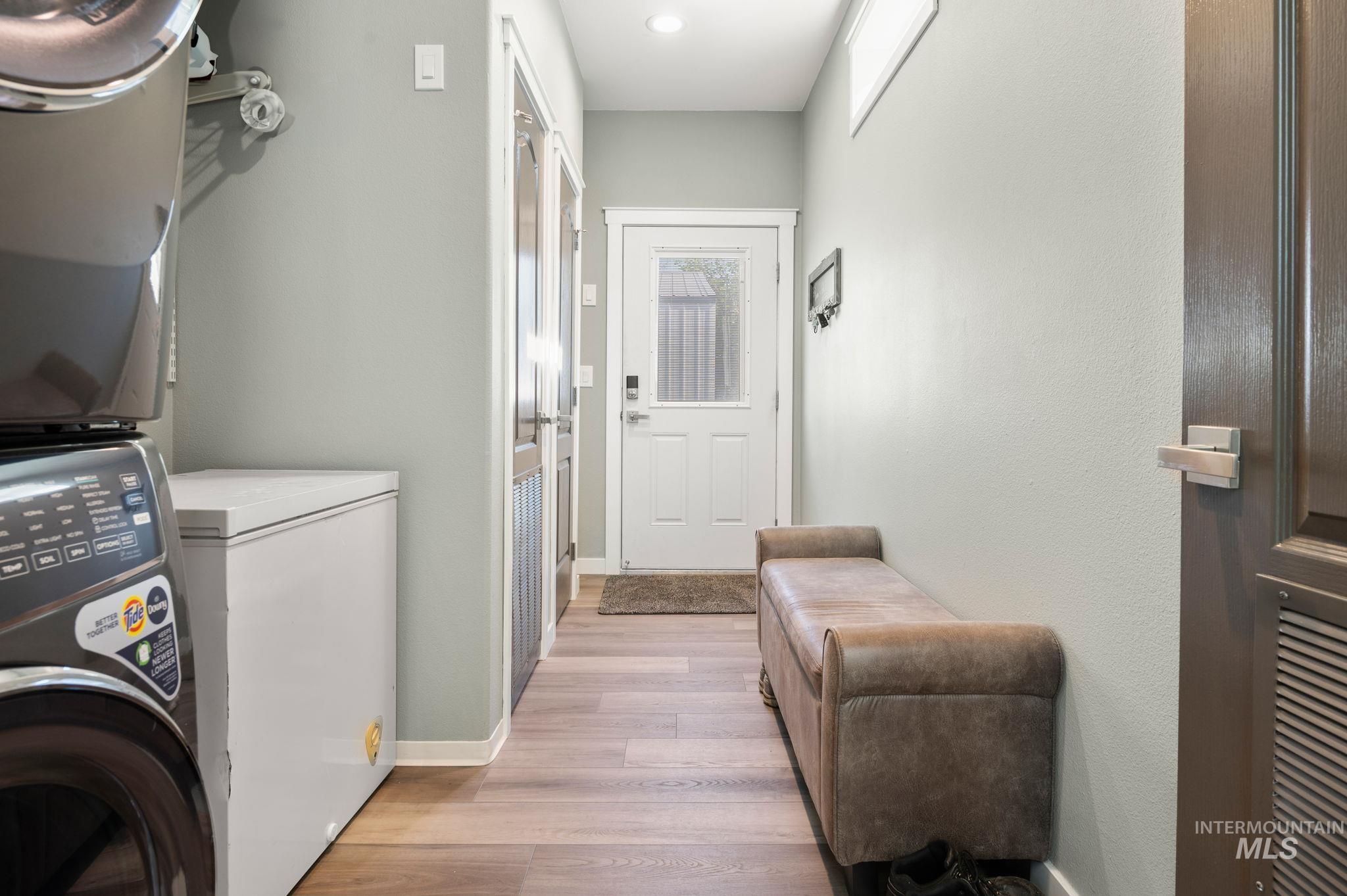 837 Burrell Avenue Lewiston, ID 83501 - Photo 28 of 32 Washroom featuring stacked washing machine and dryer and light wood-style floors