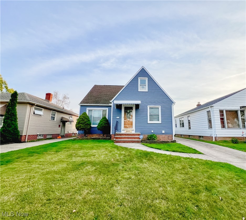 6403 Kenneth Avenue Parma, OH 44129 - Photo 1 of 20 View of front facade featuring a front yard and a shingled roof