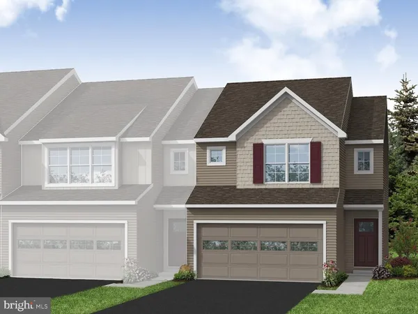 a front view of a house with a garden and garage