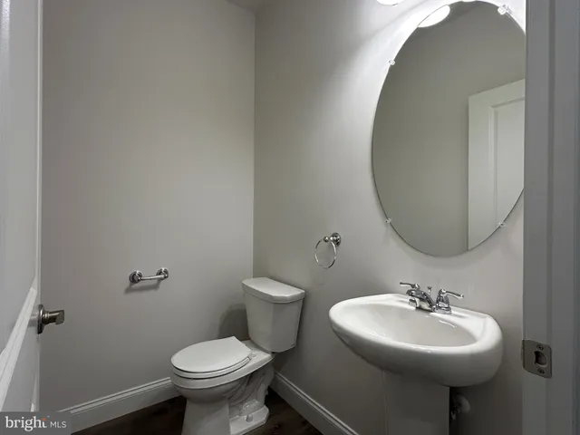 a bathroom with a sink a mirror and a toilet
