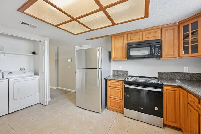 a kitchen with a refrigerator sink and stove top oven