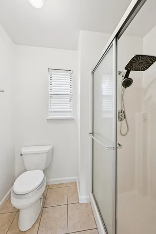 a backyard of a house with barbeque oven and brick wall
