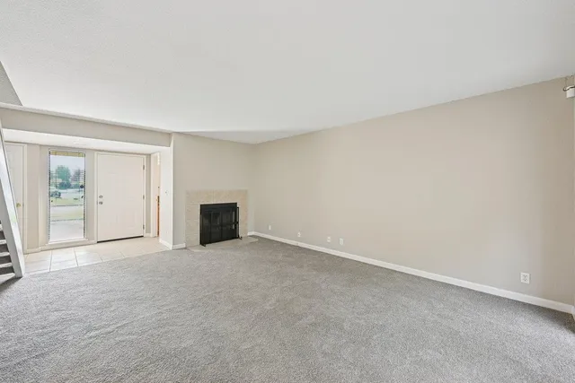 an empty room with closet and a window