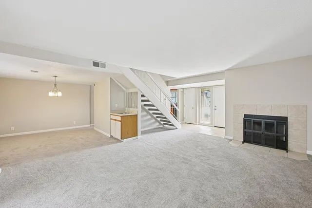 a view of an empty room with a fireplace