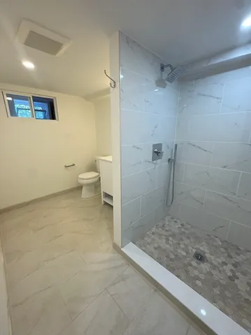 a bathroom with a toilet and a shower