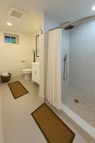a bathroom with a sink a toilet and shower