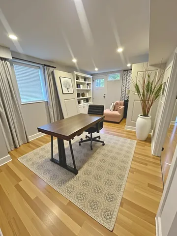 a living room with furniture rug and wooden floor
