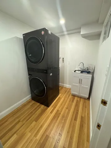 a bedroom with a bed and a washing machine in it