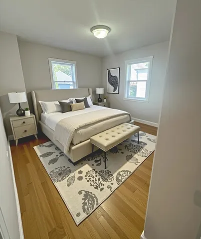 a living room with a bed furniture and a window