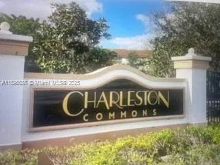 a street sign that is sitting on a brick wall