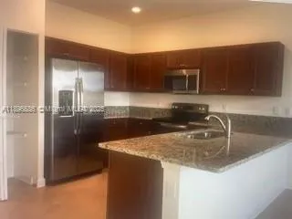 a kitchen with a sink and refrigerator