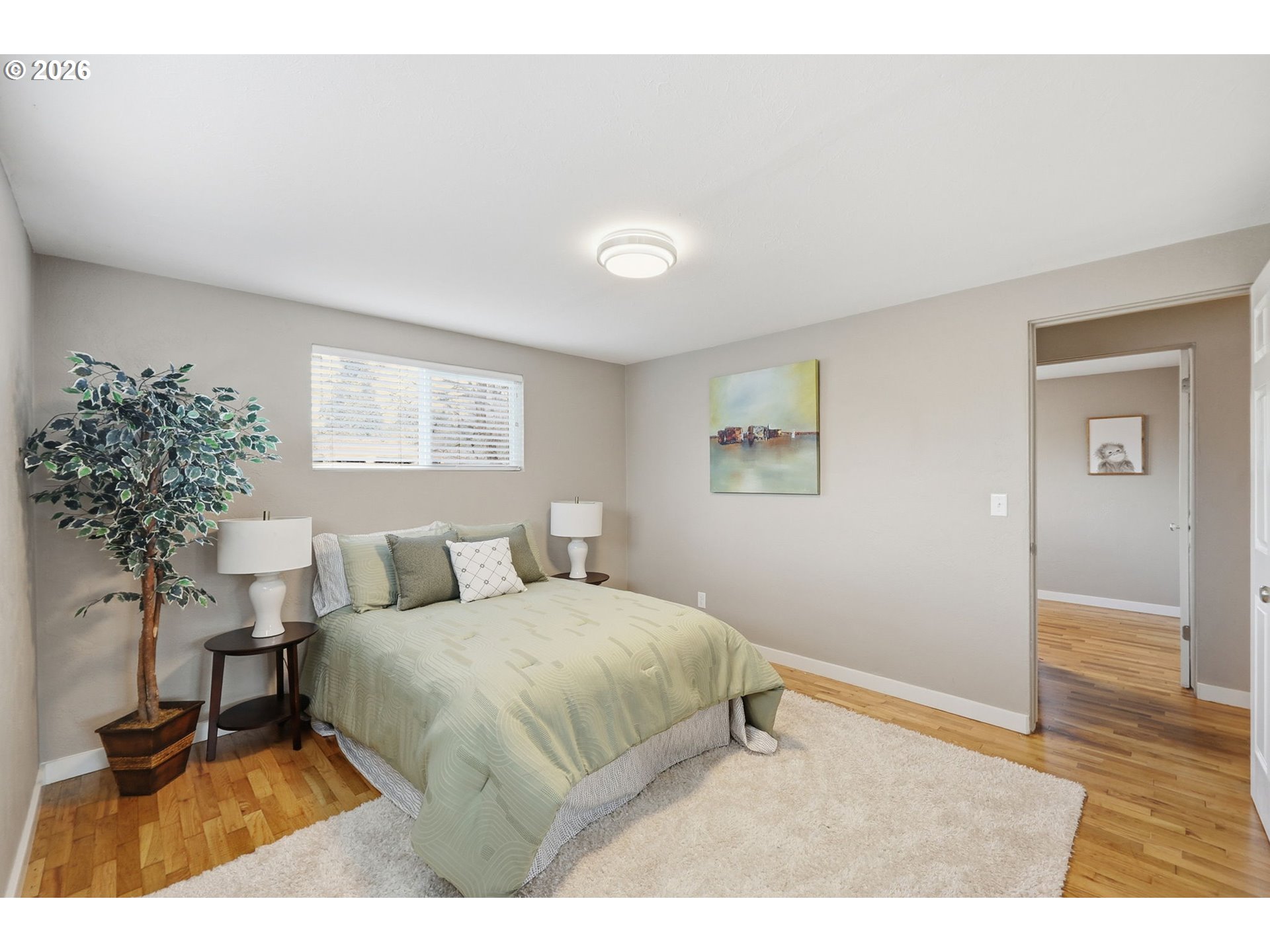 381 Marion Lane Eugene, OR 97404 - Photo 18 of 39 a bedroom with a bed and a potted plant