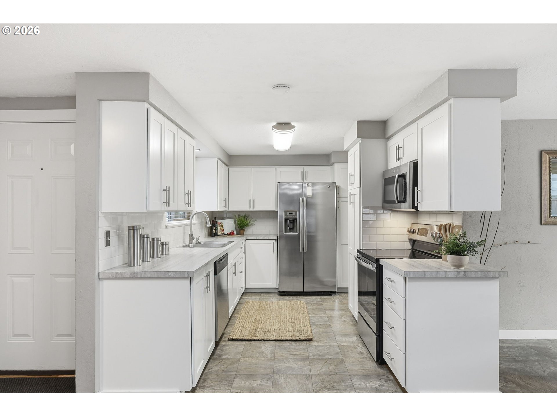 381 Marion Lane Eugene, OR 97404 - Photo 7 of 39 a kitchen with a sink a counter top stainless steel appliances and cabinets