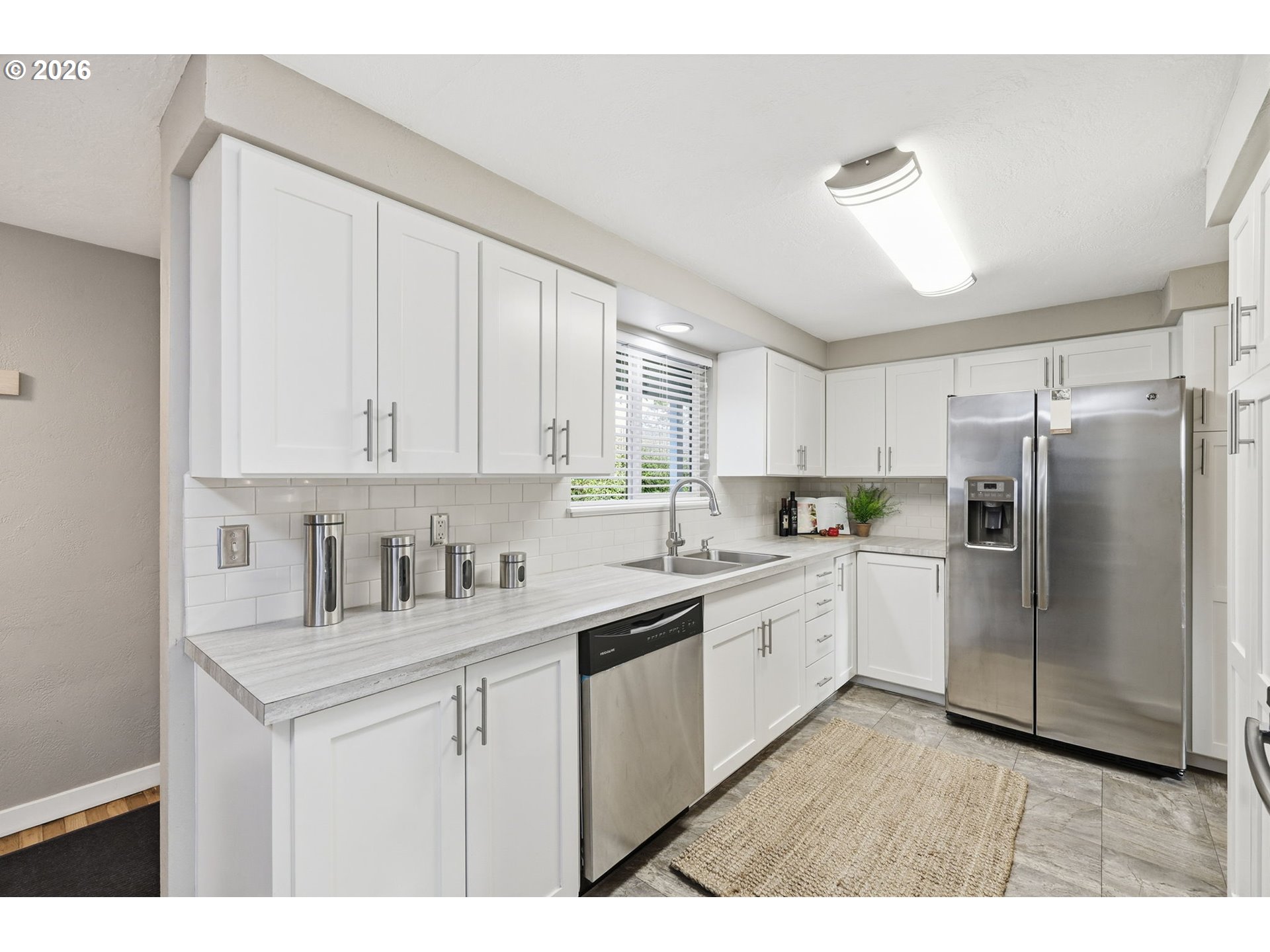 381 Marion Lane Eugene, OR 97404 - Photo 9 of 39 a kitchen with white cabinets and white appliances