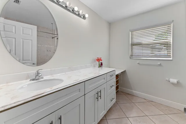a bathroom with a double vanity sink and a mirror