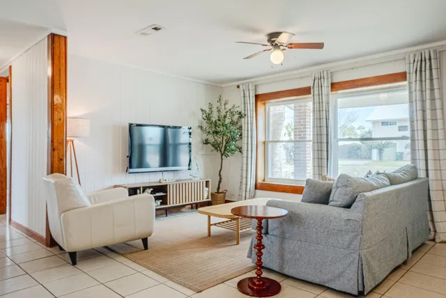 a living room with furniture and a large window