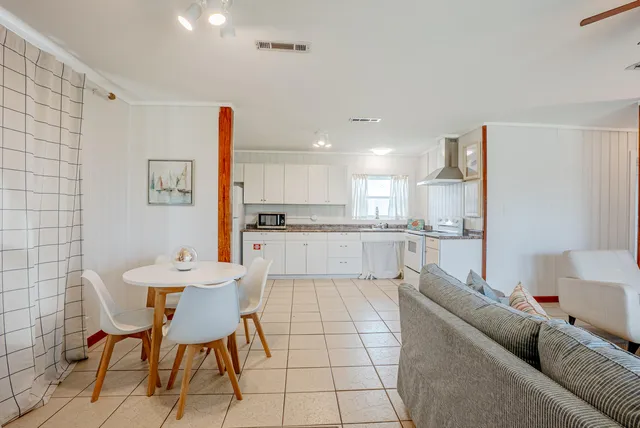 a living room with furniture and kitchen view