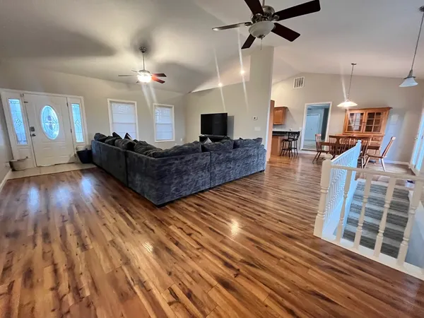 a living room with furniture and a wooden floor