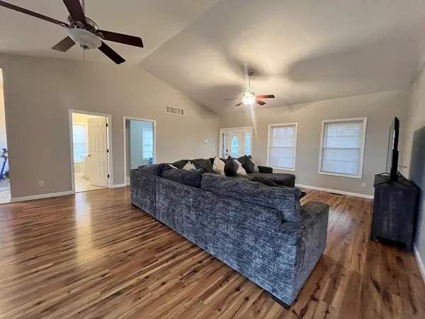 a large room with wooden floor and furniture