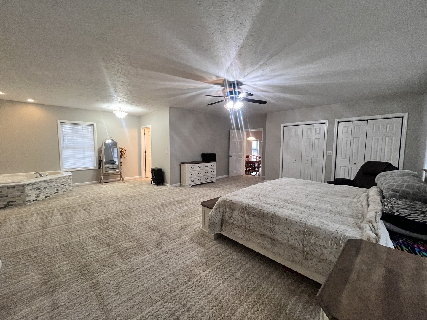 5488 Tick Ridge Road Grand Chain, IL 62941 - Photo 28 of 47 a spacious bedroom with a bed a chandelier and dresser