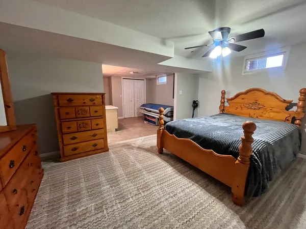 a spacious bedroom with a bed and a chandelier