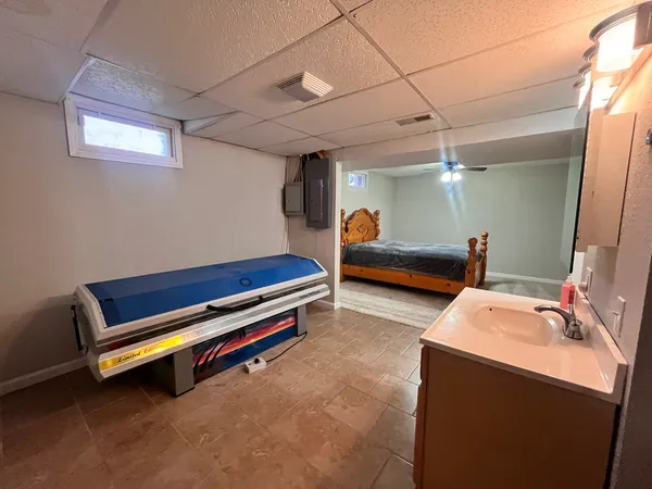 a bedroom with furniture and a air conditioner vent