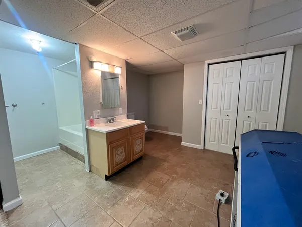 a bathroom with a double vanity sink and mirror