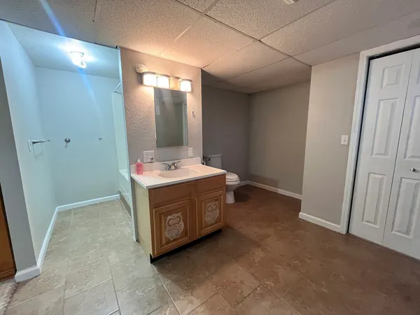 a bathroom with a sink vanity and mirror