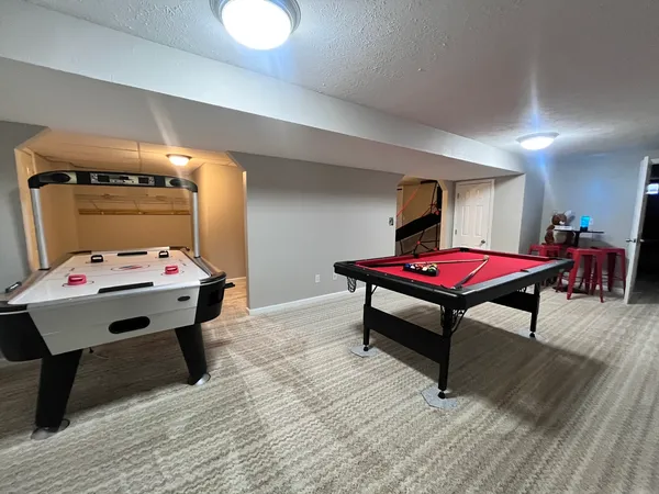 a room with furniture and pool table