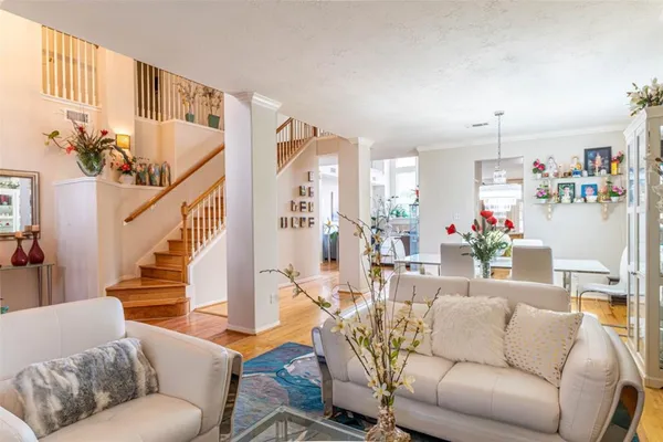 a living room with furniture and a chandelier