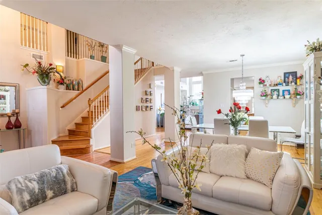 a living room with furniture and a chandelier