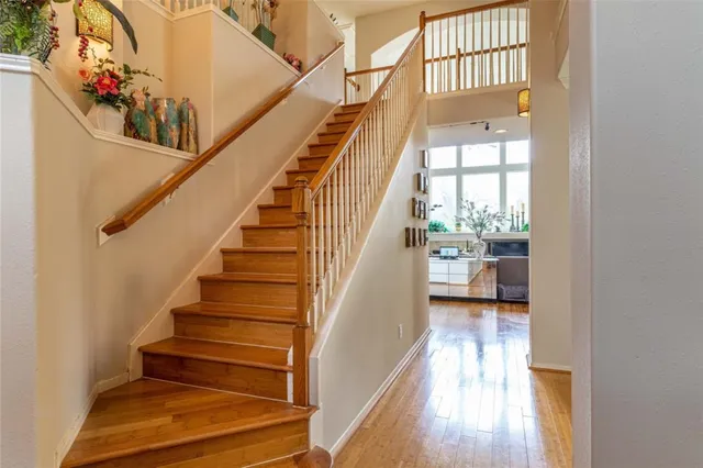a view of entryway and hall with wooden floor