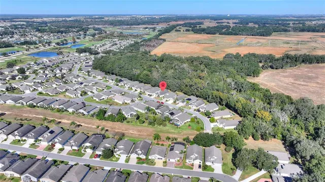 an aerial view of a house a yard swimming pool and outdoor seating