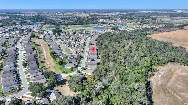 a spacious bedroom with a large bed a table and chair
