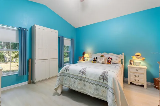 a living room with furniture a chandelier and a window