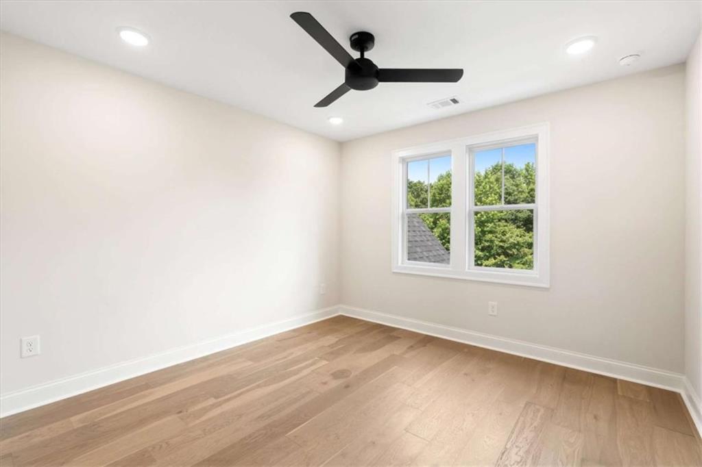 591 Welcome Road Roopville, GA 30170 - Photo 41 of 60 an empty room with wooden floor and windows