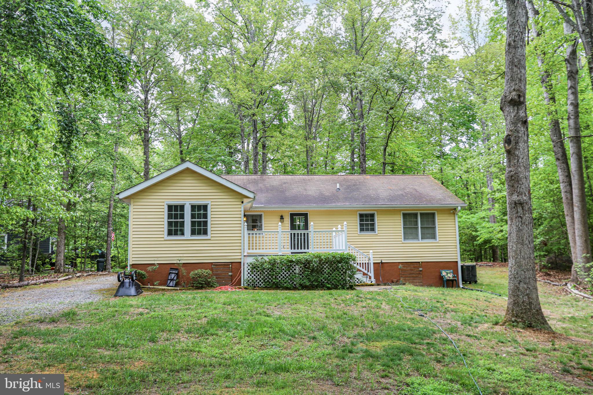 143 Cranes Corner Road Fredericksburg, VA 22405 - Photo 18 of 26 Charming home nestled in lush greenery.
