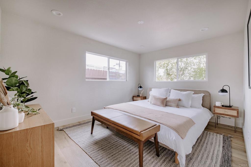 1027 San Abella Drive Encinitas, CA 92024 - Photo 9 of 27 a bedroom with a bed and a potted plant