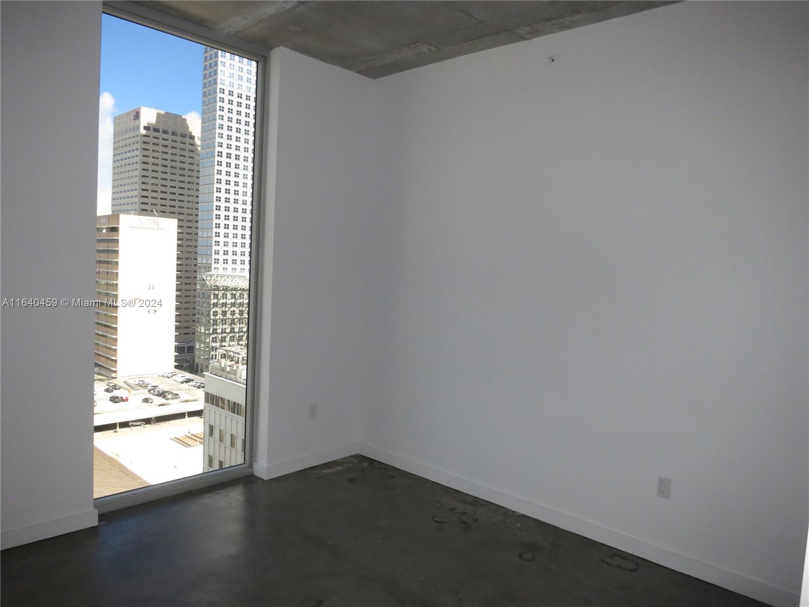 151 Southeast 1st Street, Unit 1902 Miami, FL 33131 - Photo 10 of 21 a view of an empty room and a window