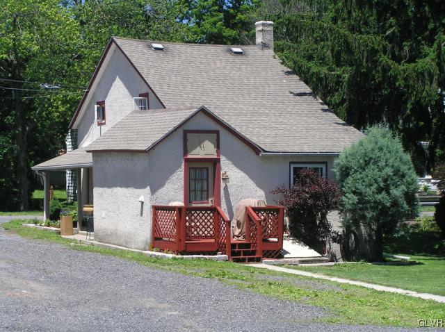 5810 Locust Valley Road Coopersburg, PA 18036 - Photo 16 of 23 a front view of a house with a yard and garage