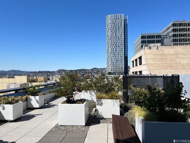 a view of a balcony with couches and wooden floor