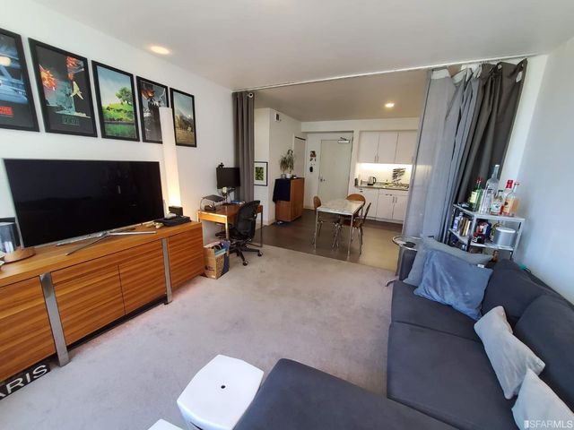 a living room with furniture fireplace and flat screen tv