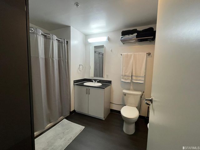 a bathroom with a toilet a sink and a window