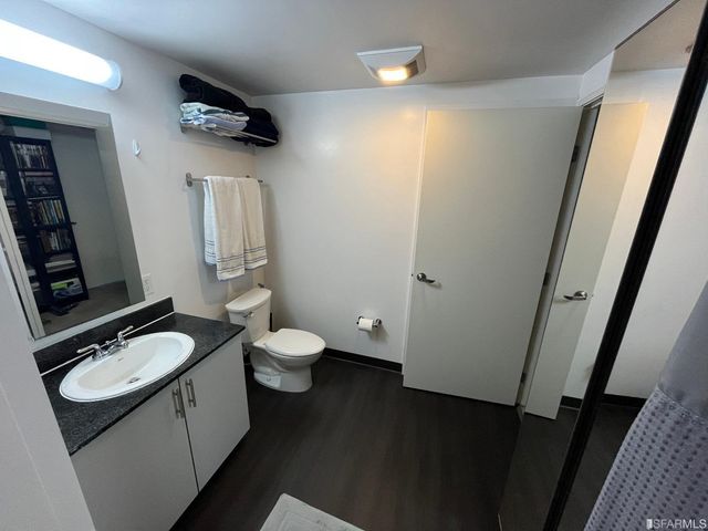 a bathroom with a toilet a sink and mirror