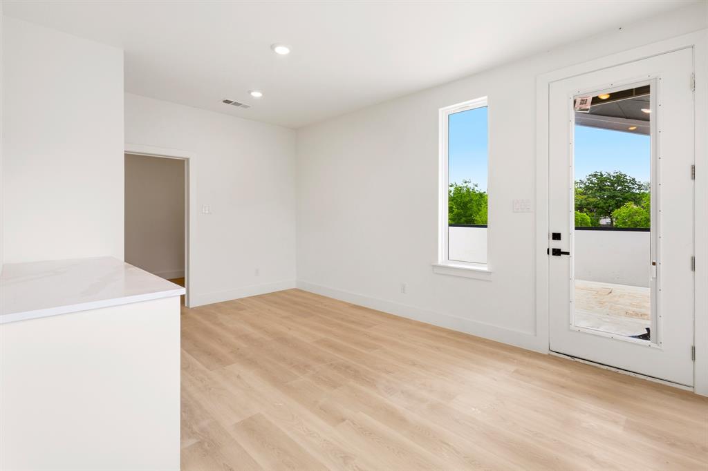 413 North Patton Avenue Dallas, TX 75203 - Photo 19 of 21 a view of empty room with window and wooden floor