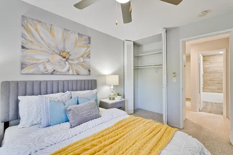a bedroom with a bed and a window