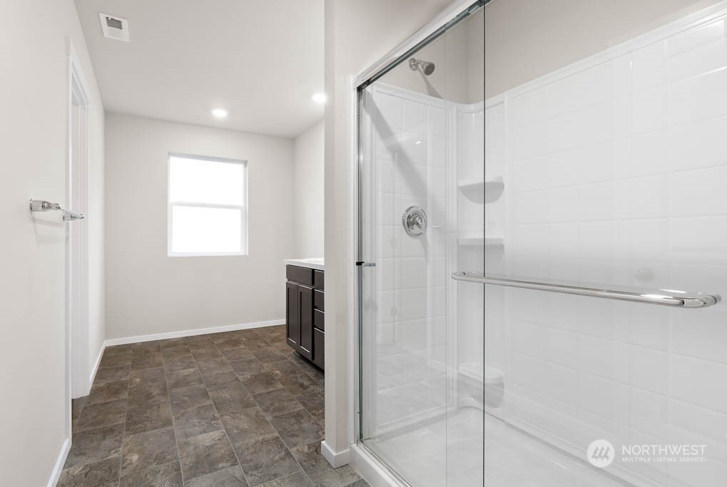 18937 Liberty Rdg Lane, Unit 955 Puyallup, WA 98374 - Photo 11 of 19 a bathroom with a shower and a glass door