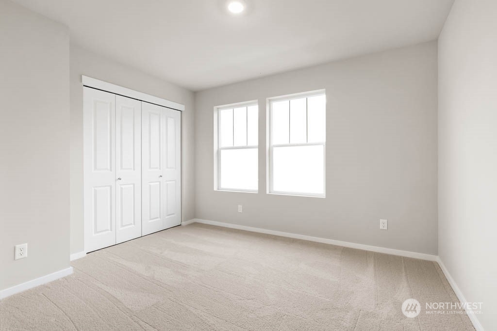 18937 Liberty Rdg Lane, Unit 955 Puyallup, WA 98374 - Photo 13 of 19 an empty room with windows