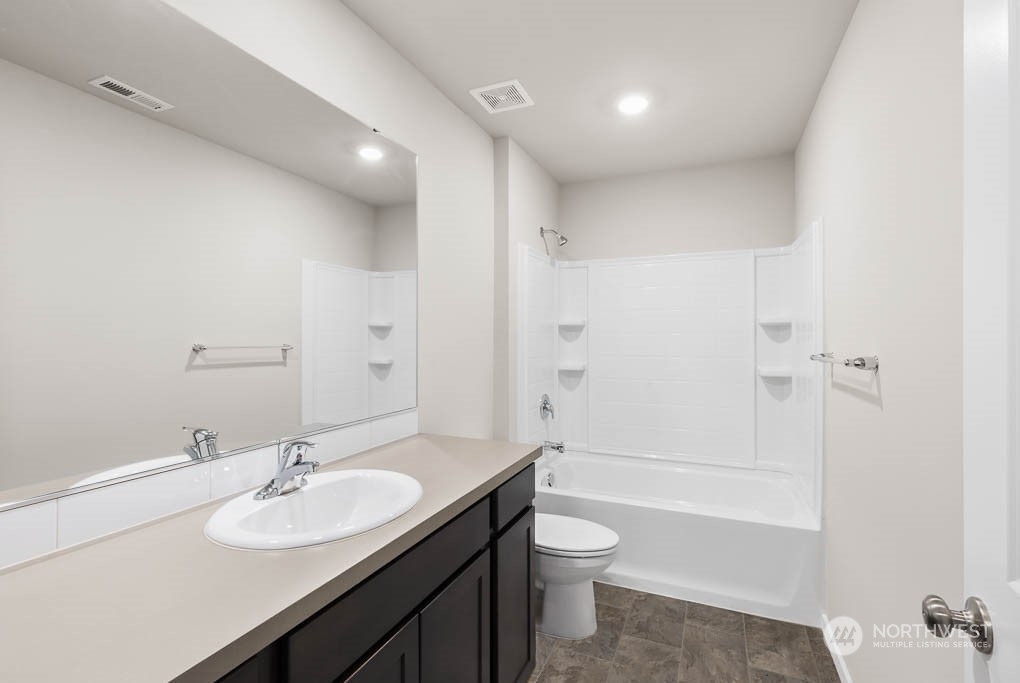 18937 Liberty Rdg Lane, Unit 955 Puyallup, WA 98374 - Photo 15 of 19 a bathroom with a sink toilet a shower and a tub